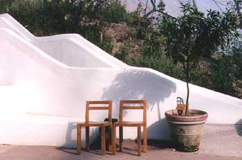The Eden Project: two chairs and an adobe wall in the semi-arid biome